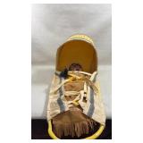 Native American cradleboard with a doll inside
