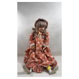 Large 28" vintage doll wearing a floral dress and