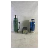 Two vintage thermoses and a pay phone coin box