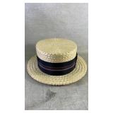 A vintage brooks brothers hat box with a straw