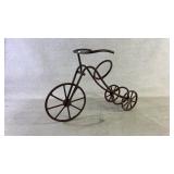A metal tricycle wine holder