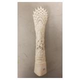 Carved bone sculpture featuring intricate patterns