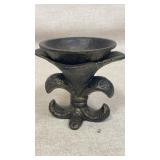 Cast iron holder with ornate fleur-de-lis base.