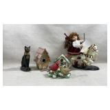 collection of figurines, including a black cat, a