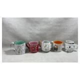 collection of ceramic mugs with various designs,