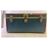 A large blue/green storage trunk