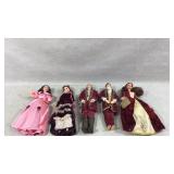 Five Barbies dressed in 19th-century attire.