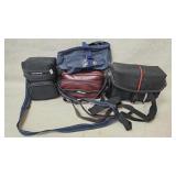 Cameras and their bags and one singular bag with