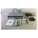 Two dvd players with accessories powers on