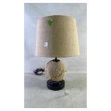 A table lamp with a rope ball base and rope shade