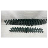 green metal picket fences