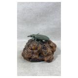 Copper beetle on wood stand