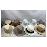 collection of assorted Panama straw hats in