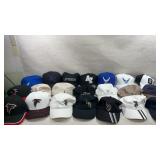 collection of assorted baseball caps, including