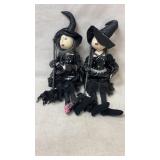Halloween witch dolls, one has wax on foot and
