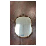 antique wall mirror with a carved wooden frame