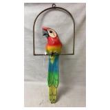 hand-painted macaw parrot sculpture mounted on a