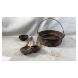 large vintage cast iron cauldron with utensils