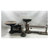 Two vintage cast iron balance scales and a set