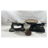 Two vintage cast iron balance scales and a set of
