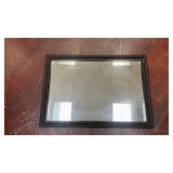 large, rectangular black ornate wall mirror with