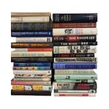 Hardcover books from various genres and authors.