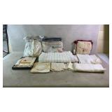 Assortment of antique linens, tablecloths, and