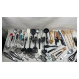 large collection of kitchen utensils, including