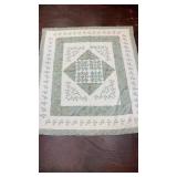 handmade medallion-style quilt features a