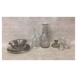 Includes a decanter, cups, and silver-accented bow