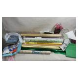 assortment of rolled gift-wrapping paper, tissue