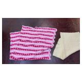 two handmade crochet blankets one with pink,