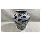 hand-painted ceramic vase featuring traditional