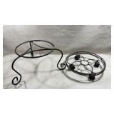 black scrollwork plant stand on the left and a
