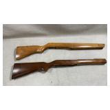 two wooden rifle stocks