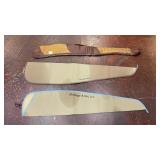 three soft gun cases or slips laid out on a