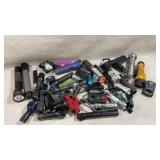 large pile of various portable lighting devices,