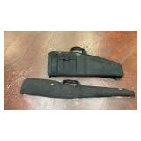 two black soft-sided long gun cases: a tactical
