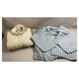 two classic cable-knit Aran sweaters: an