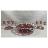 console set featuring a cranberry glass and