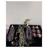 SELECTION OF MARTI GRAS BEADS AND ORNAMENTS