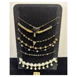 7 COSTUME JEWELERY NECKLACES WITH STAND