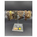 SELECTION OF 9  COSTUME BRACLETS WITH HOLDER