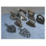 6 antique irons and 2 trivets