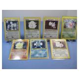 Seven Pokemon Trading Cards In Protectors