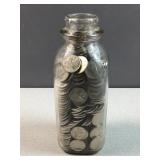 Vintage glass milk bottle with 400 nickels