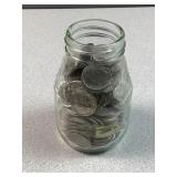 Vintage glass bottle with 200 dimes