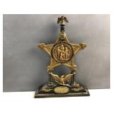 decorative desk stand featuring the badge of the