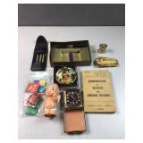 Pens, John Deere belt buckle, matchbooks, and