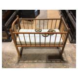 Wooden baby bed with cushion and wheels